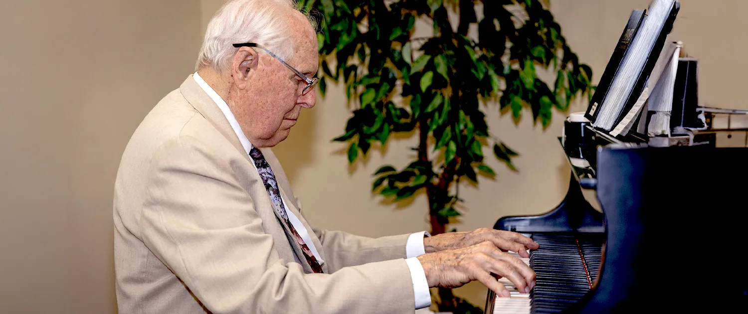 A resident playing hymns at the piano