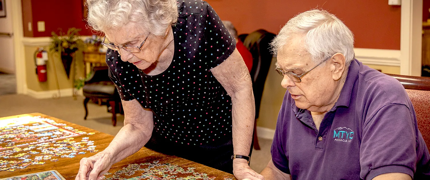 Residents working on a puzzle together